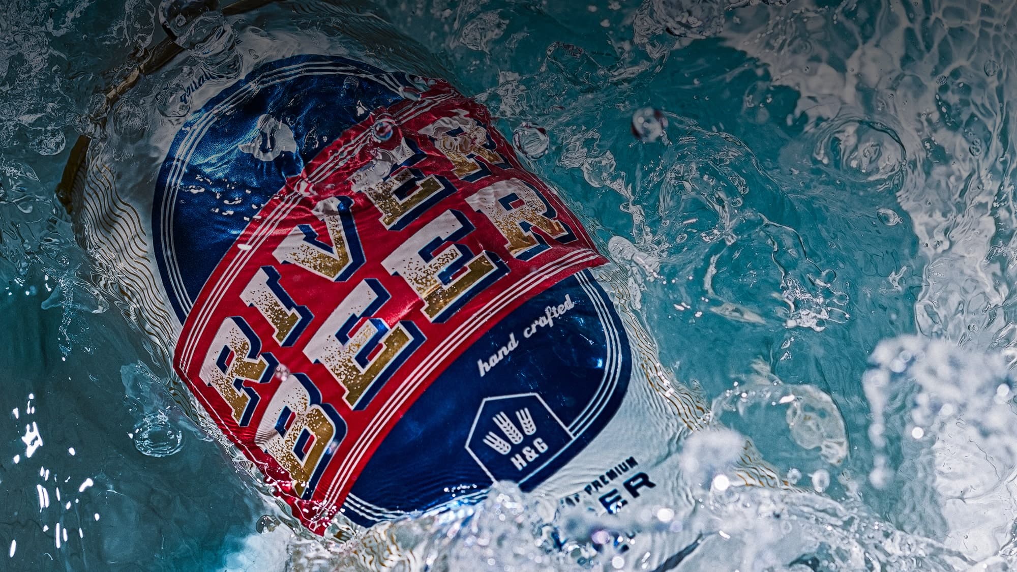 Beer splashing into water